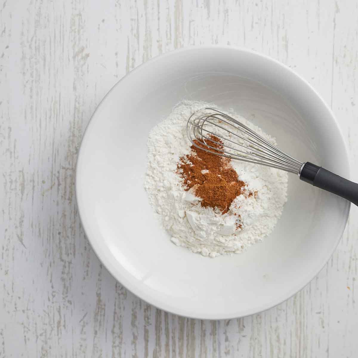White bowl with flour and spices.