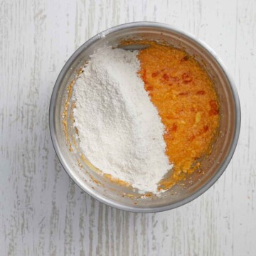 Flour mixture added to the bowl with the orange wet ingredients.