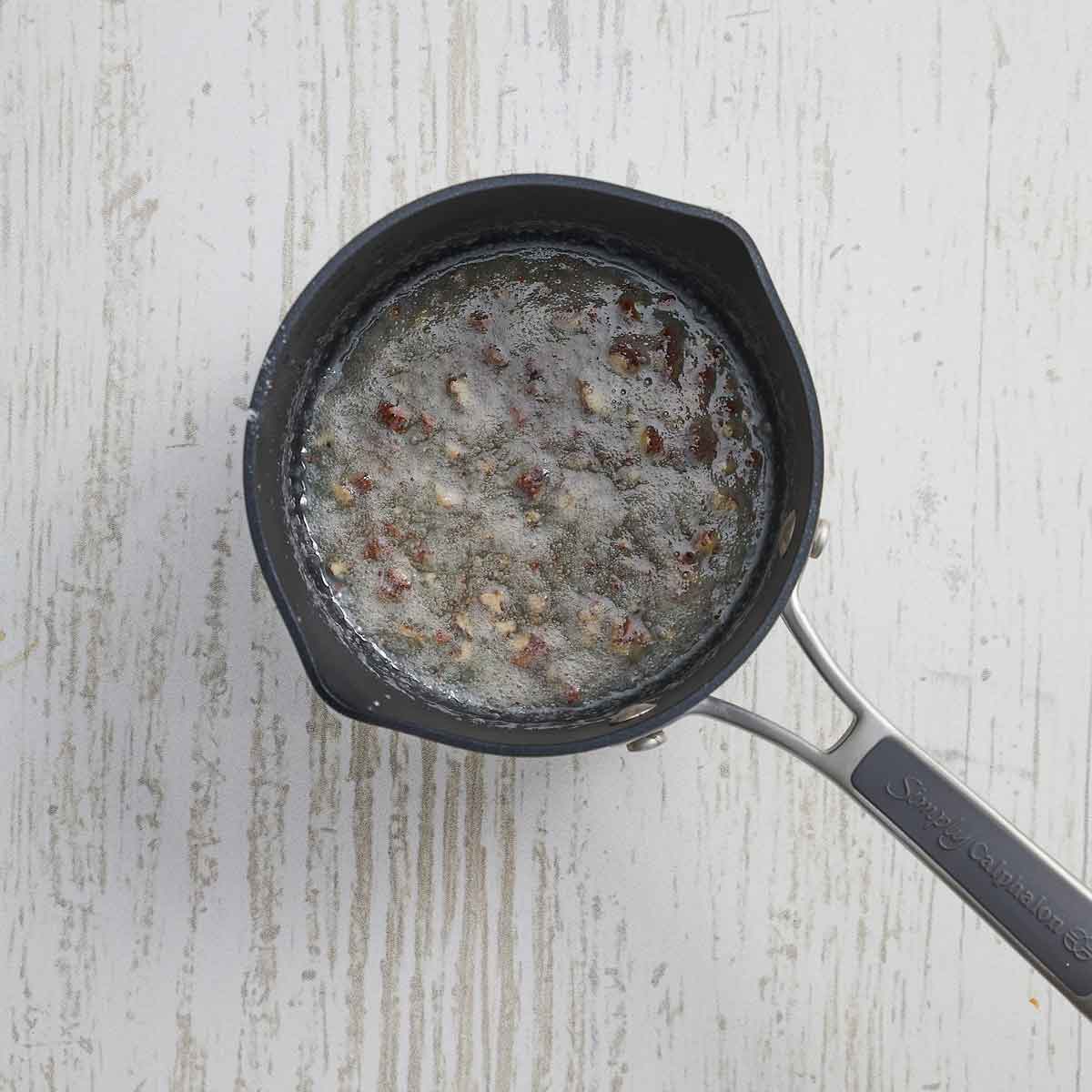 The cream has been added to the sugar mixture and cooked.