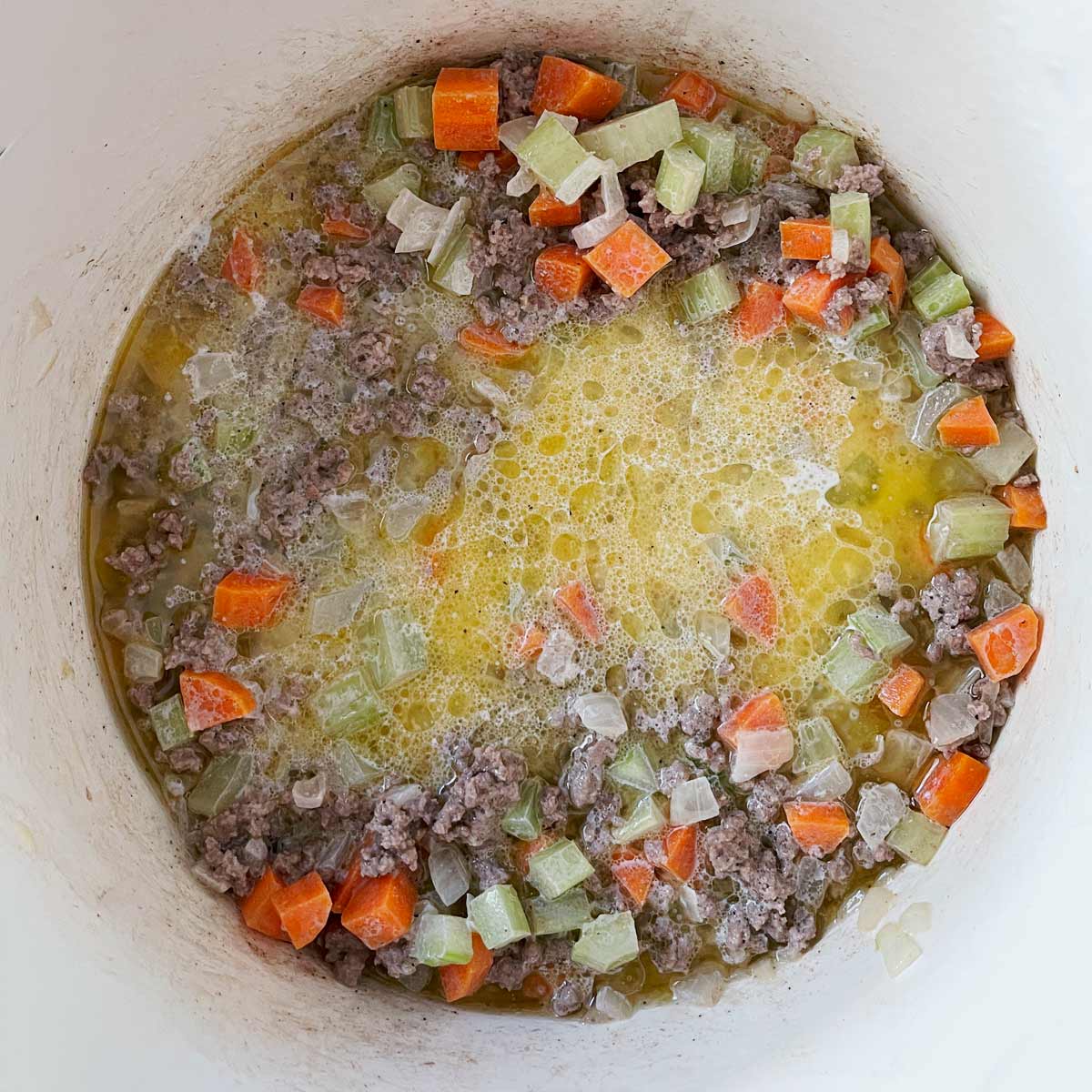 Image of the cooking pot with whole milk added.