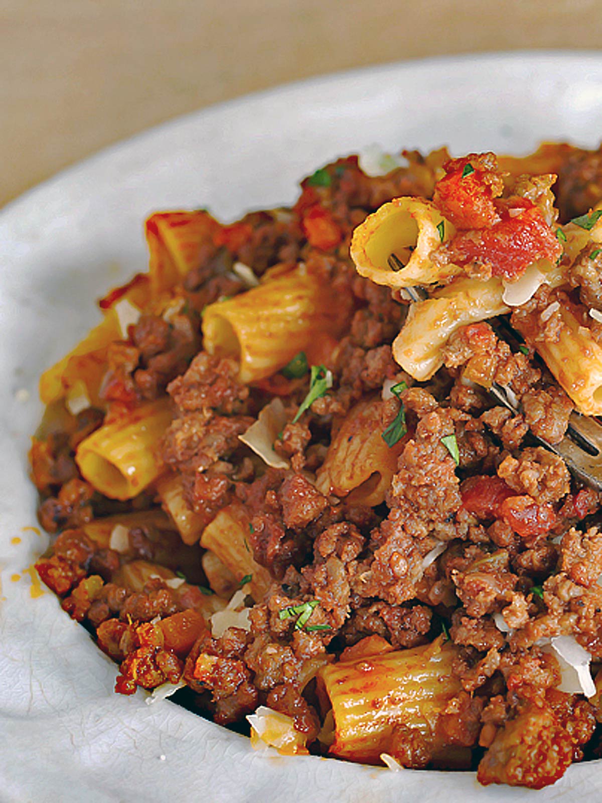 Bowl of bolognese with rigatoni noodles.