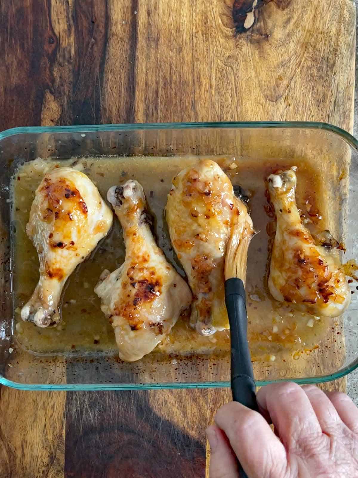 chicken being brushed with the sauce.