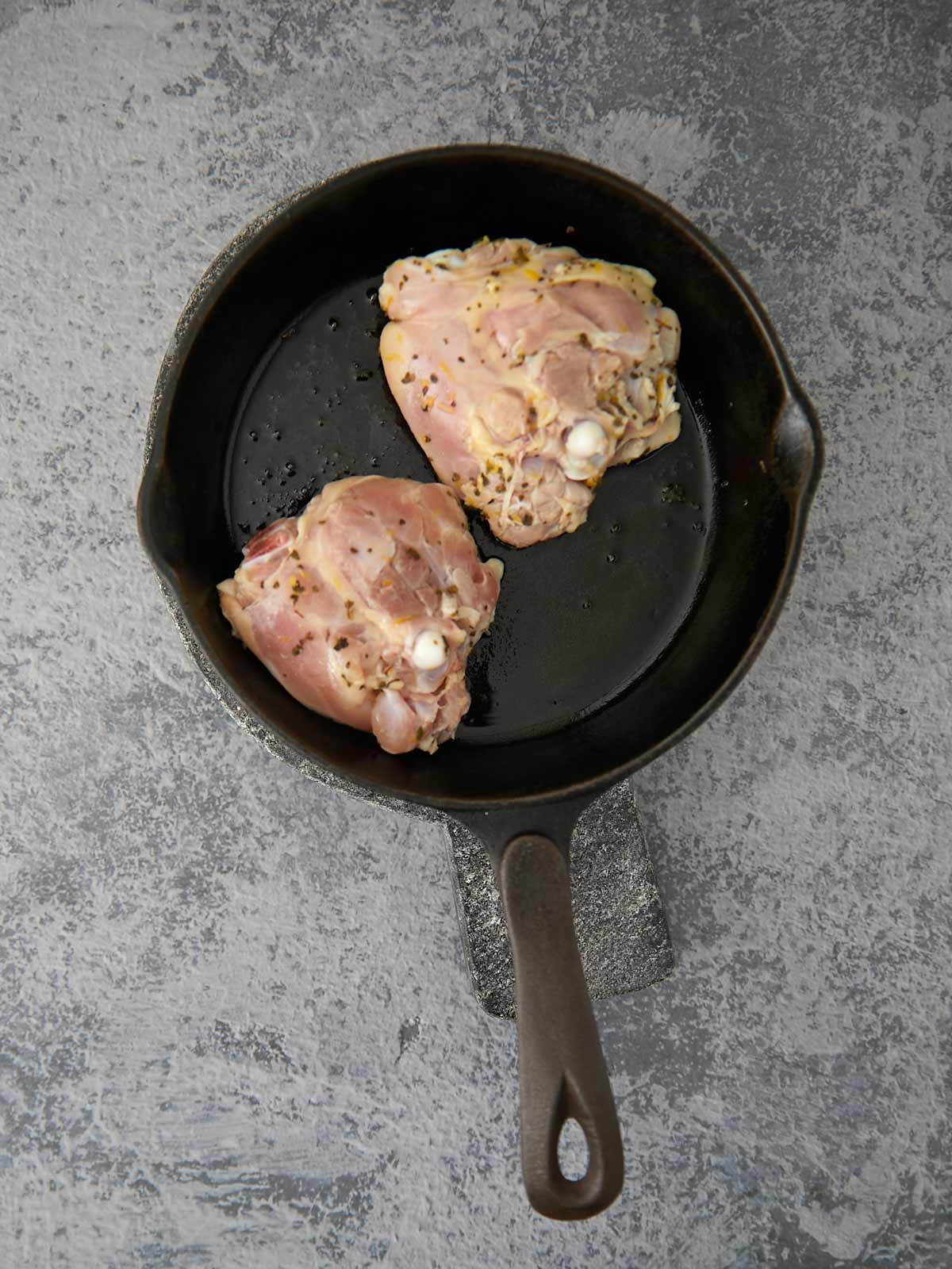 Chicken thighs flipped to cook the other side.