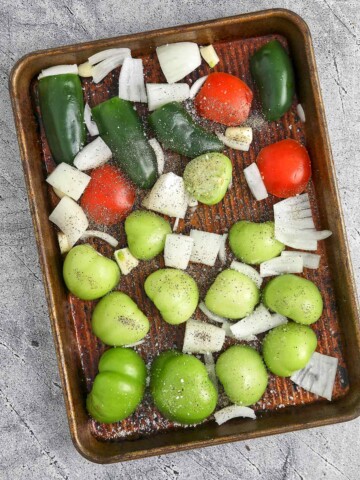 Baking sheet with the vegetables tossed with oil and sprinkled with salt and pepper.