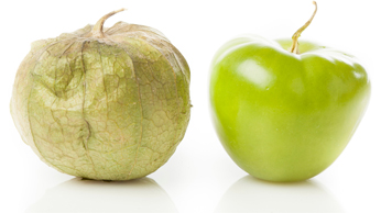 Side by side tomatillos, one with husk, and one without.