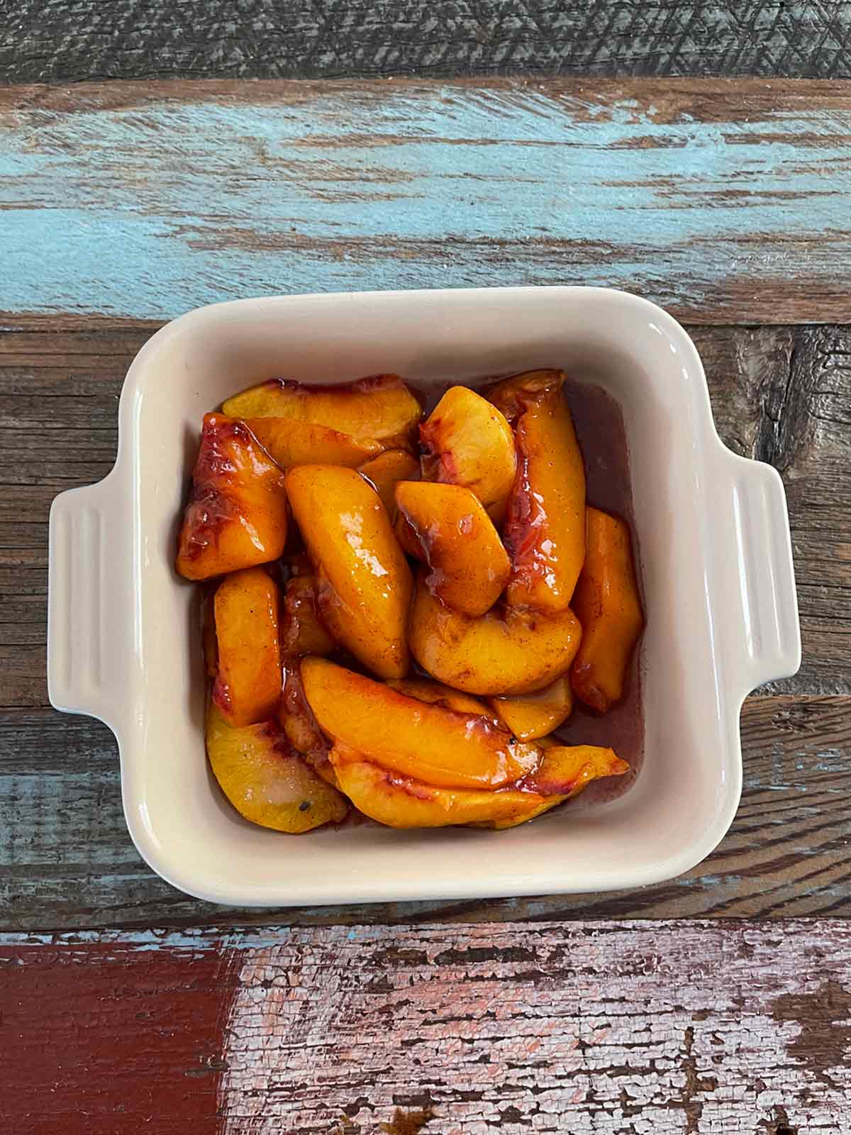 Peaches in a small rectangular baking dish.