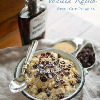 Bowl of oatmeal with raisins, cream, and turbinado sugar.
