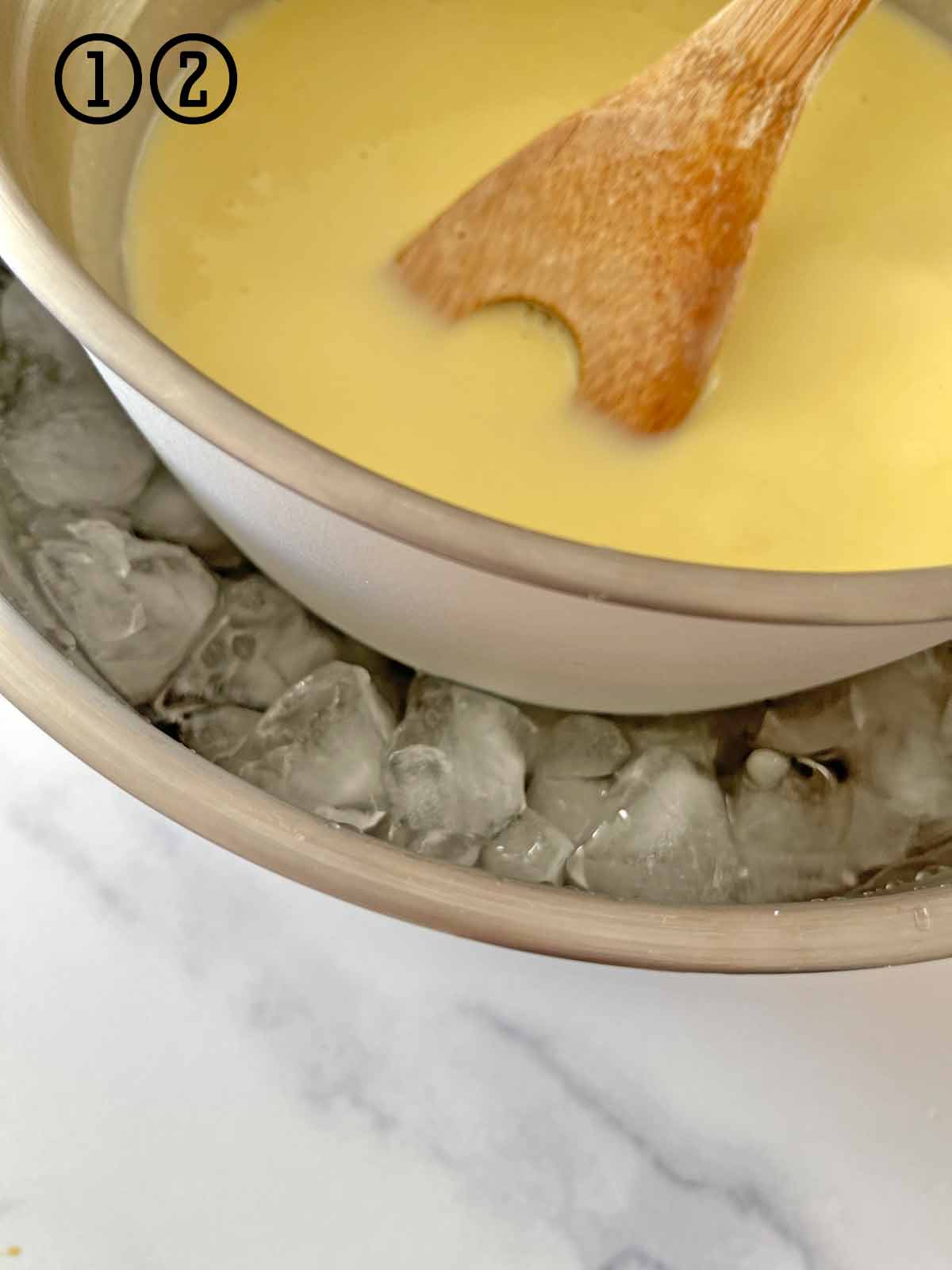 A bowl filled with ice cream base over an ice bath.
