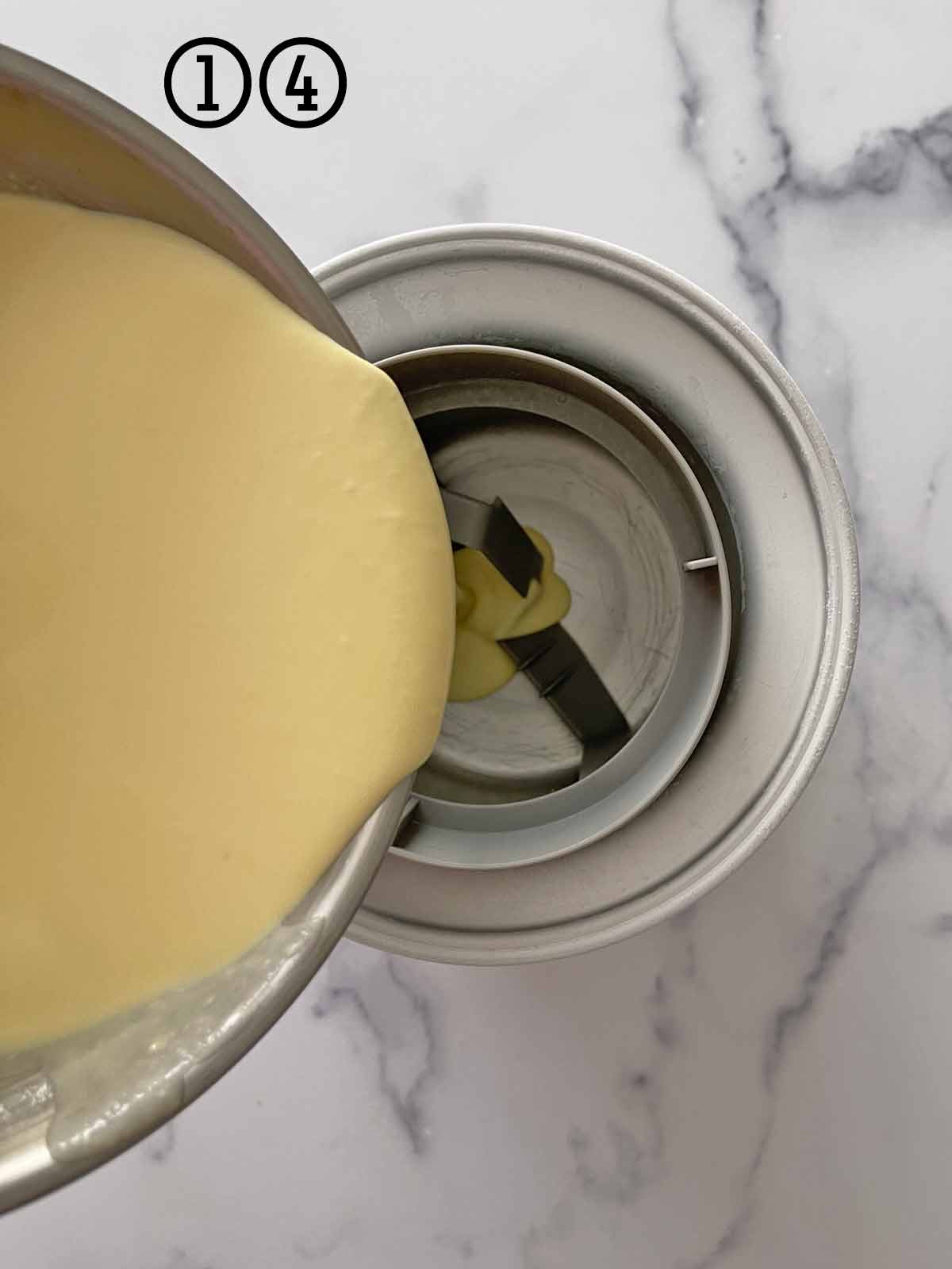 Pouring ice cream base into the frozen chamber of the ice cream maker.