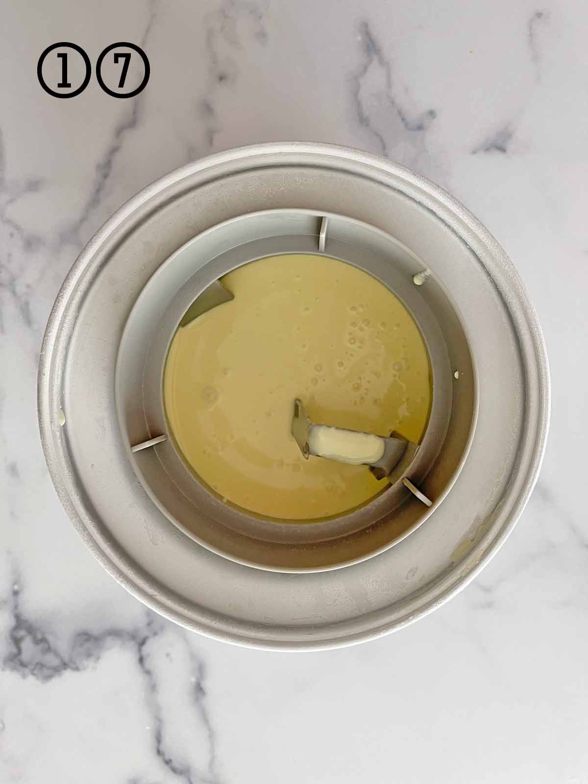 Ice cream base in the ice cream maker bowl ready to begin churning.