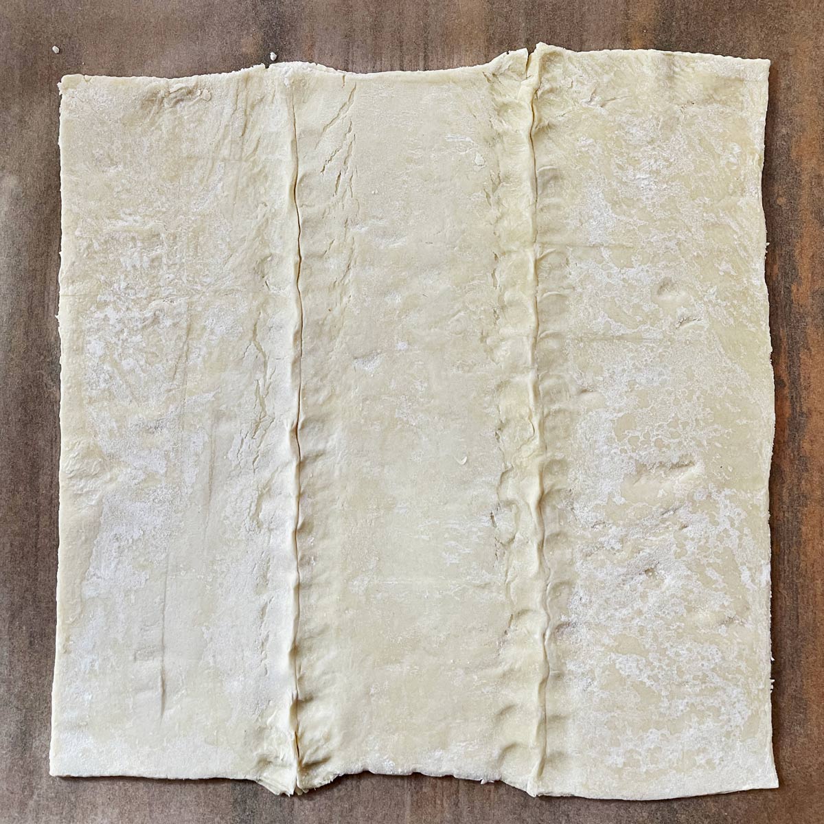 Puff pastry opens with seams pinched.