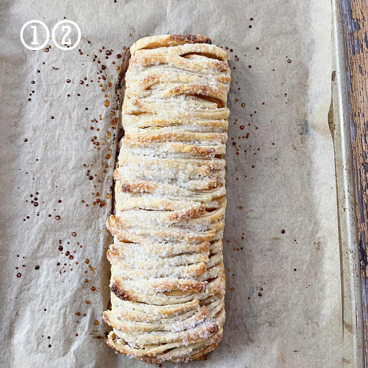 A delicious cinnamon roll sitting on a baking sheet.