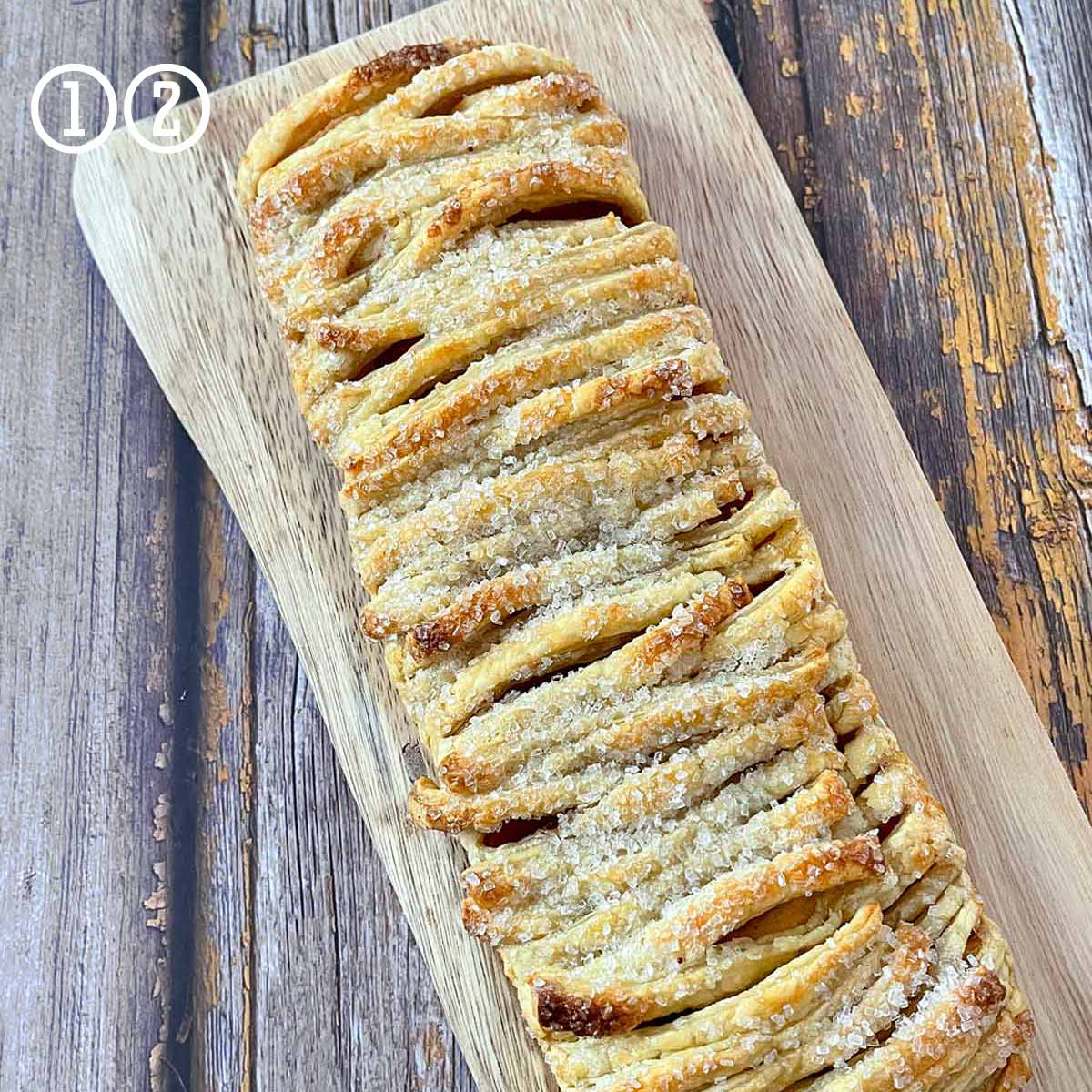 An easy apple pastry recipe (strudel) on a wooden cutting board.
