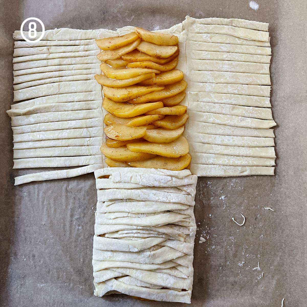 An easy apple puff pastry recipe with a sheet of pastry dough and apples on it.