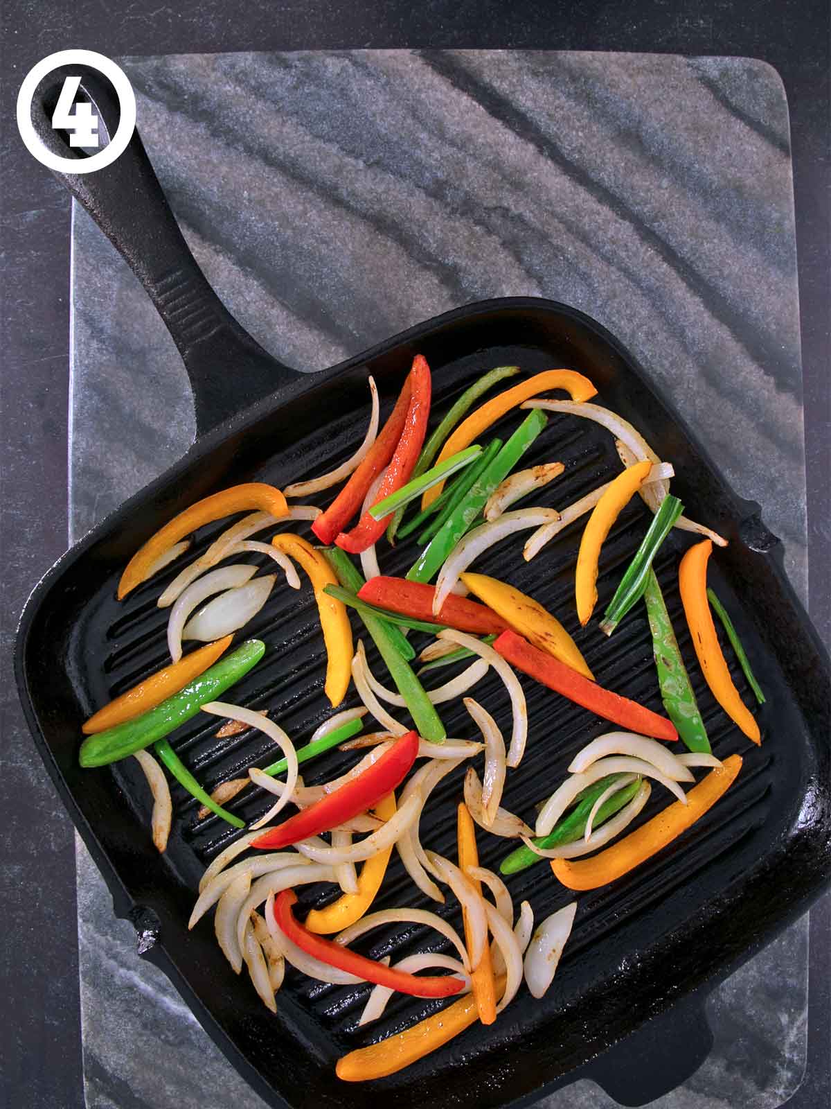 A frying pan with Grilled Chicken Fajitas, peppers and onions.