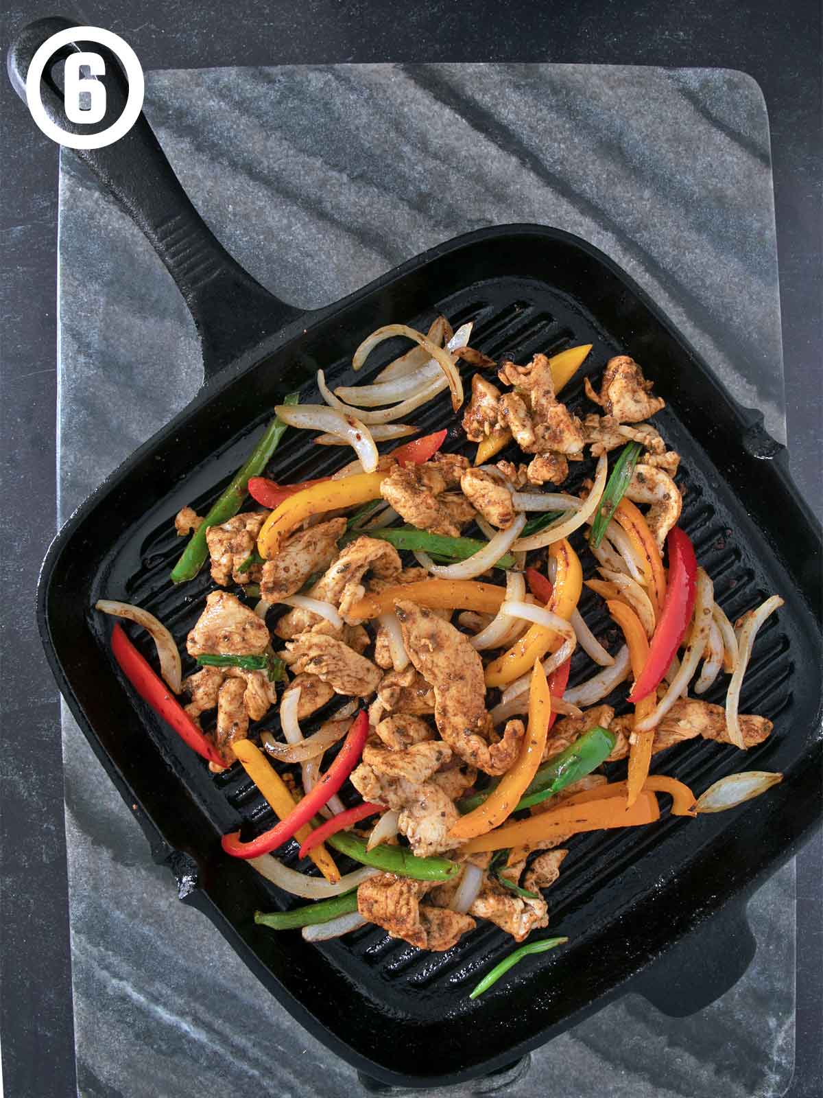 Grilled Chicken Fajitas sizzling on a pan.