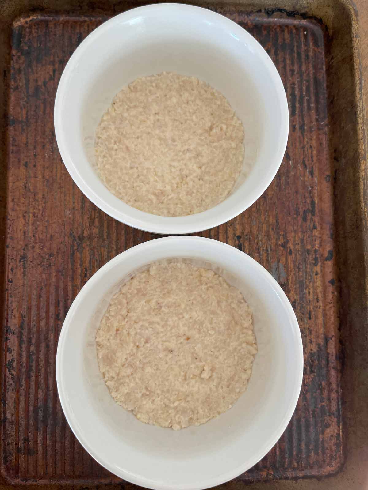 Crust pressed into the bottoms of two ramekins.