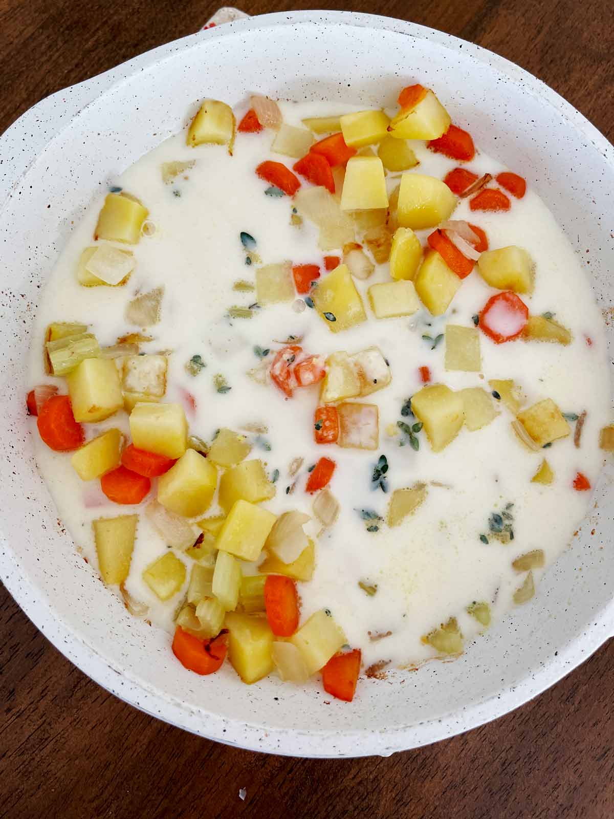 Liquid poured into the skillet with the partially cooked vegetables.