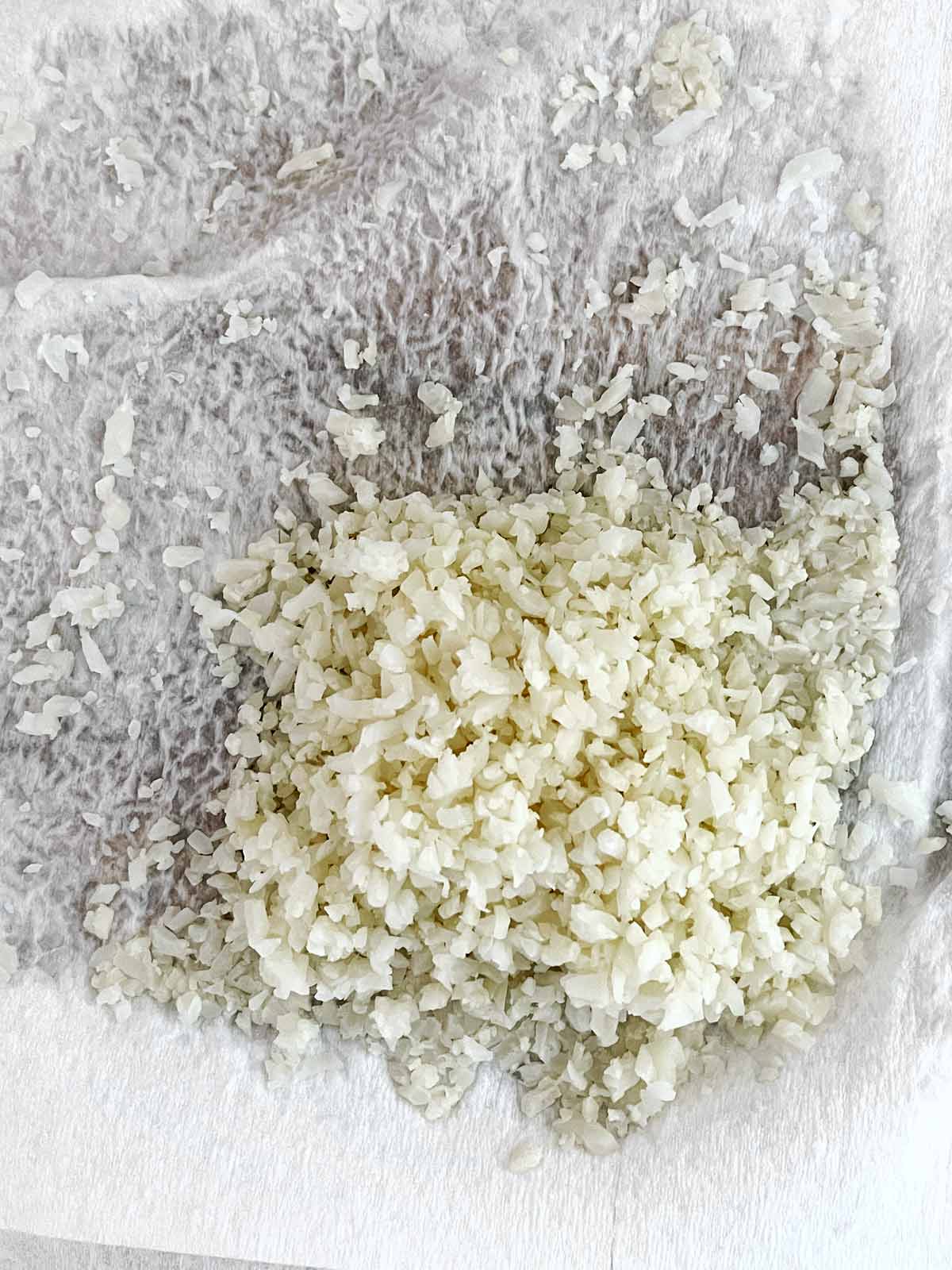 Rice on wet paper towels showing how much water was removed.