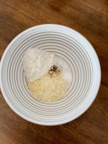 Bowl with flour, Parmesan, salt,and pepper.