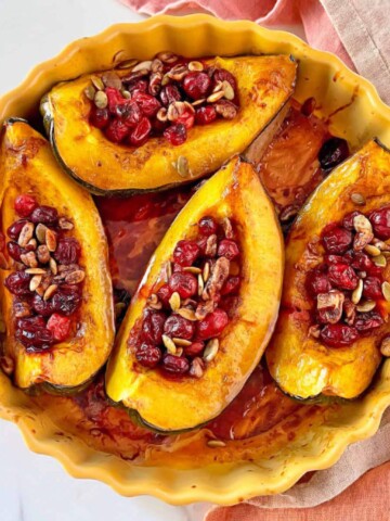 Butternut squash sllcies with. cranberries and nuts.