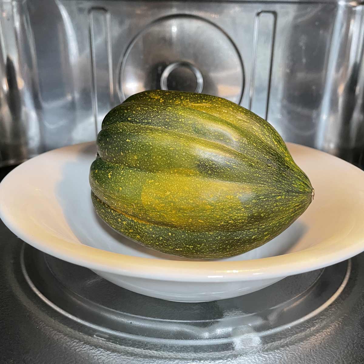Acorn squash cooking in the microwave.