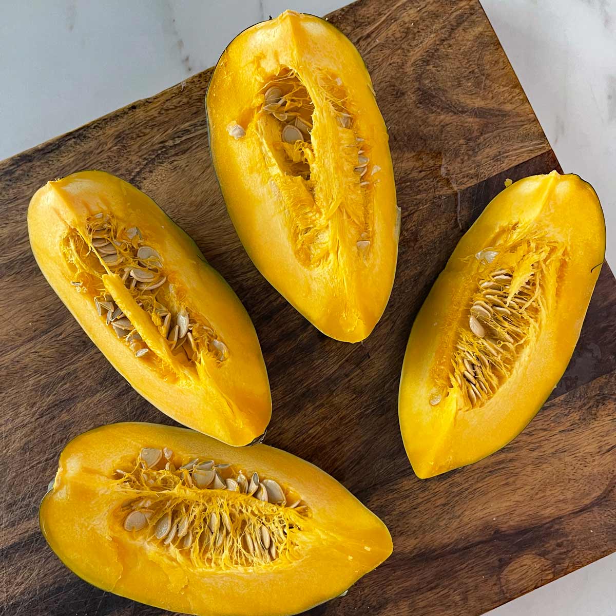 Acorn squash cut into fourths.