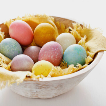 Wooden bowl with colored Easter Eggs.