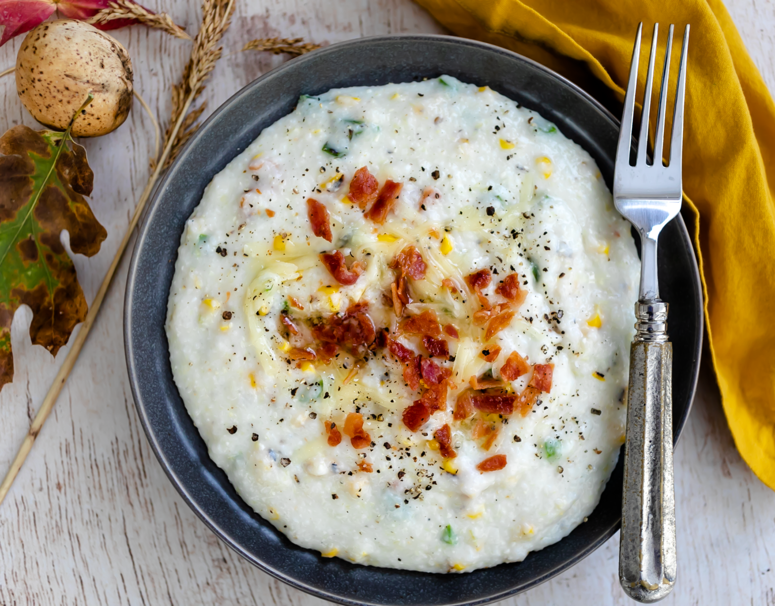 Bowl of Tex Mex grits with melting butter and cheese