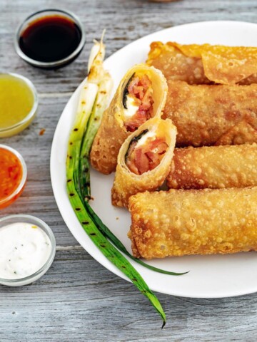Plate of eggrolls with 4 sauces.
