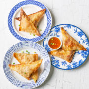 The plates of pizza pockets with dipping sauce.