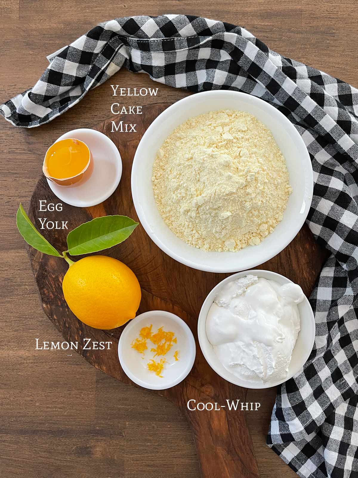 Ingredients for Powdered Sugar Lemon Cookies. Cake mix, egg yolk, lemon and Cool-Whip.