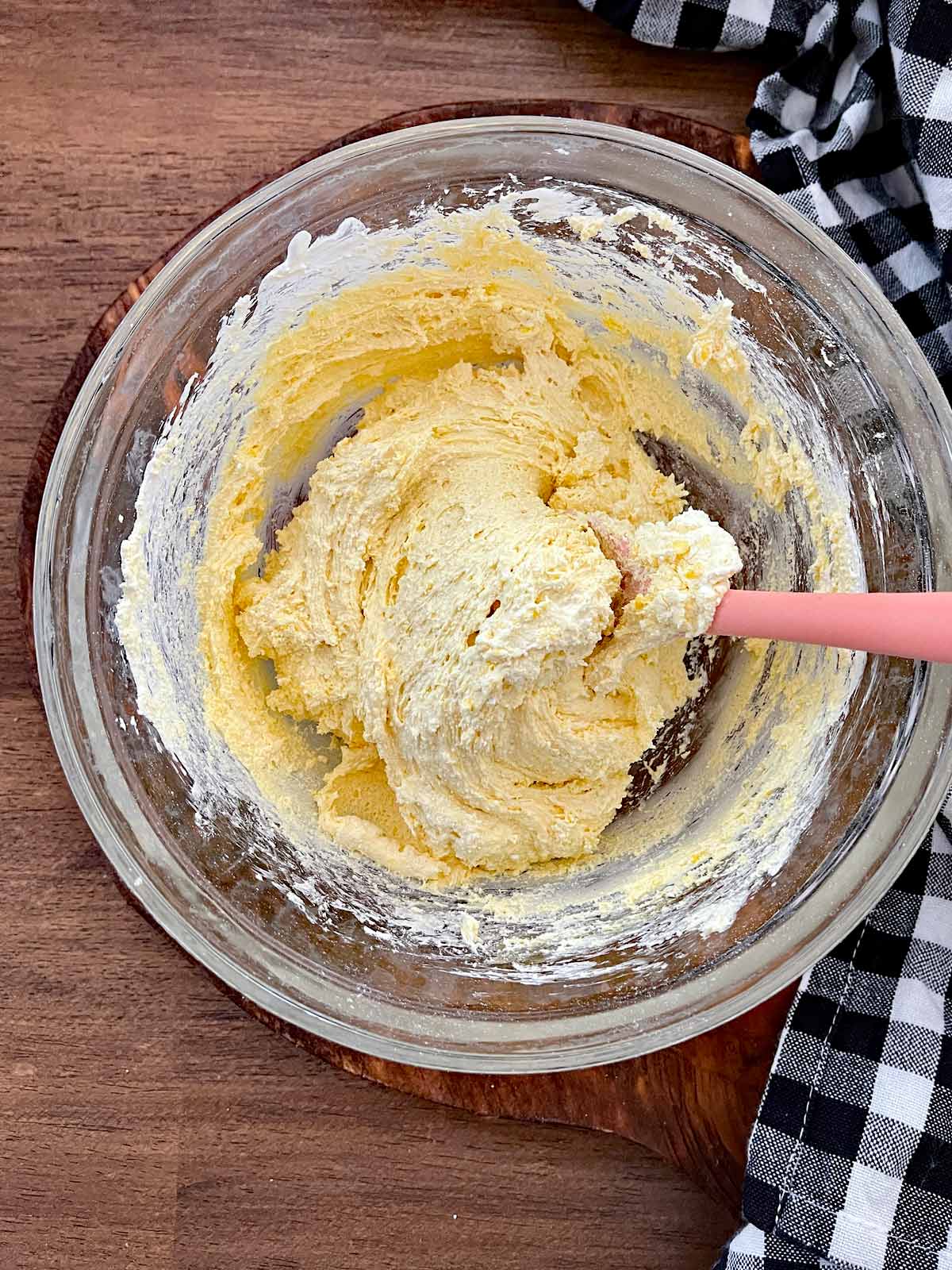 Yellow cookie dough mixed up in a bowl.