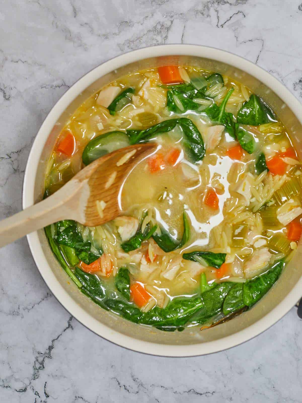 Spinach has wilted in the hot soup.