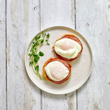 English muffin haves with poached eggs on top.