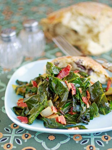 Image of a plate of mixed greens on a tablecloth.