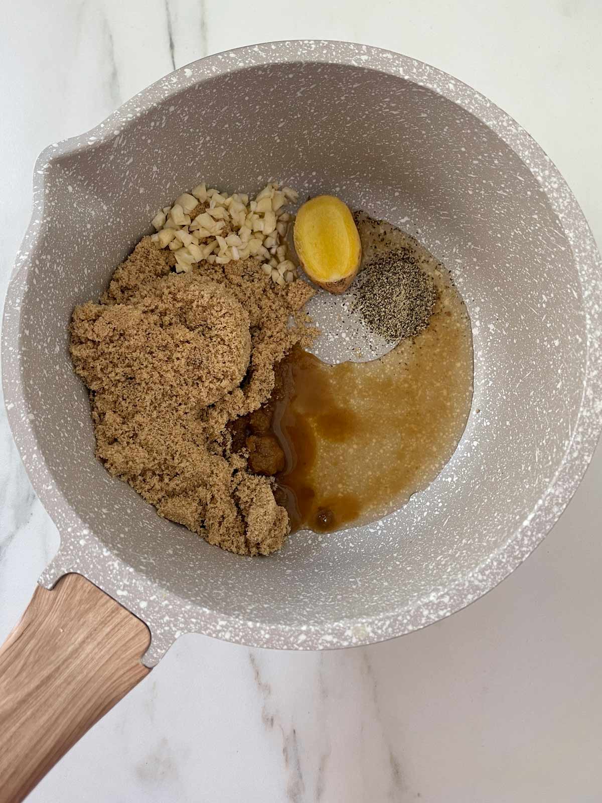 Medium pot with brown sugar, garlic, ginger, pepper, and vinegar.