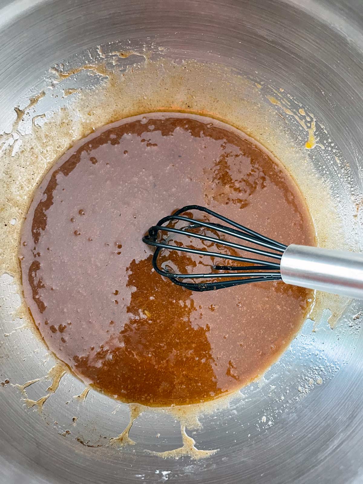Mixed wet ingredients with whisk in bowl.