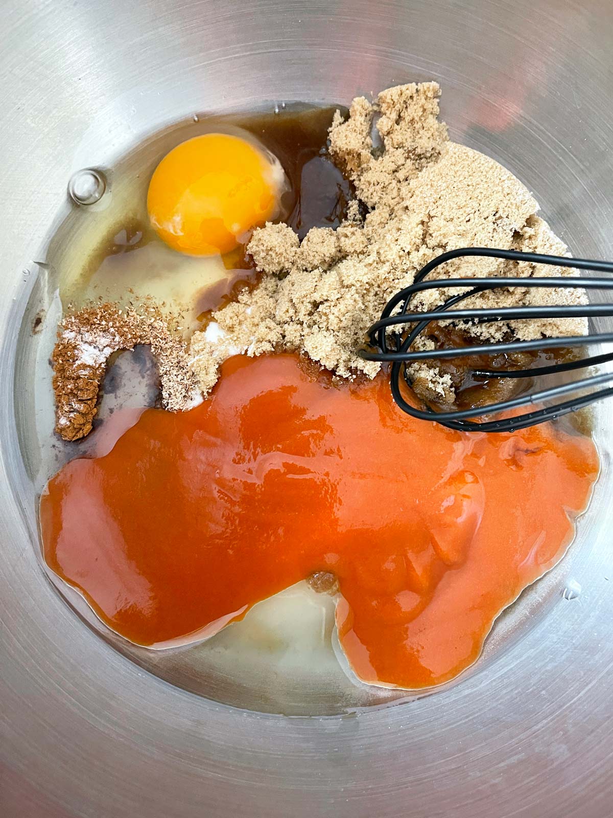 Wet ingredients plus eggs and sugars in a big bowl.