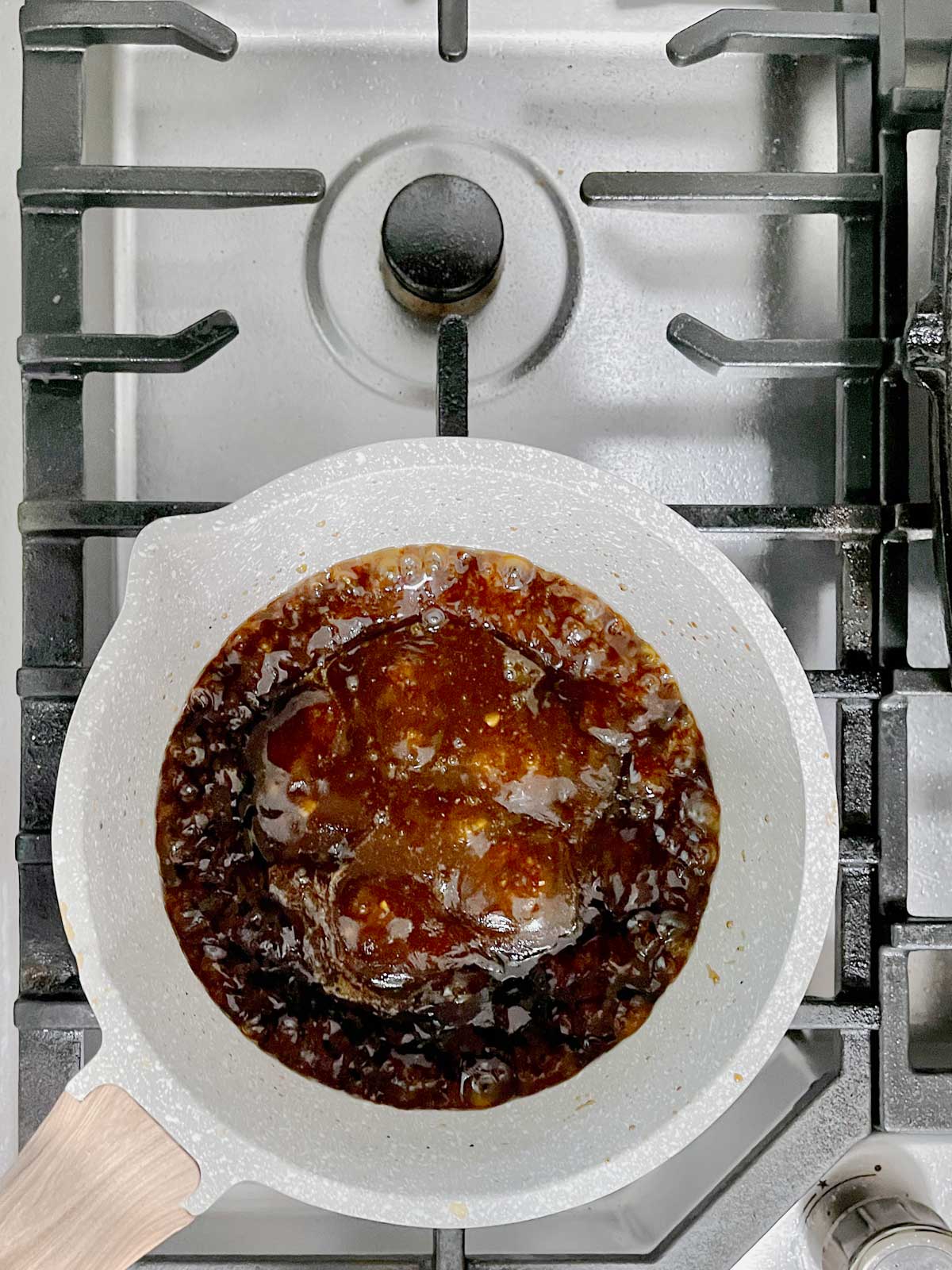 Sauce bubbling in the pot on the stove.