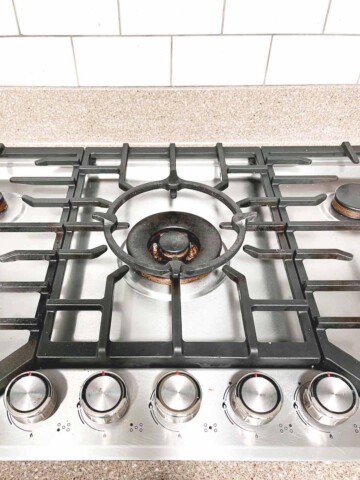 Stovetop with raised wok burner in center.