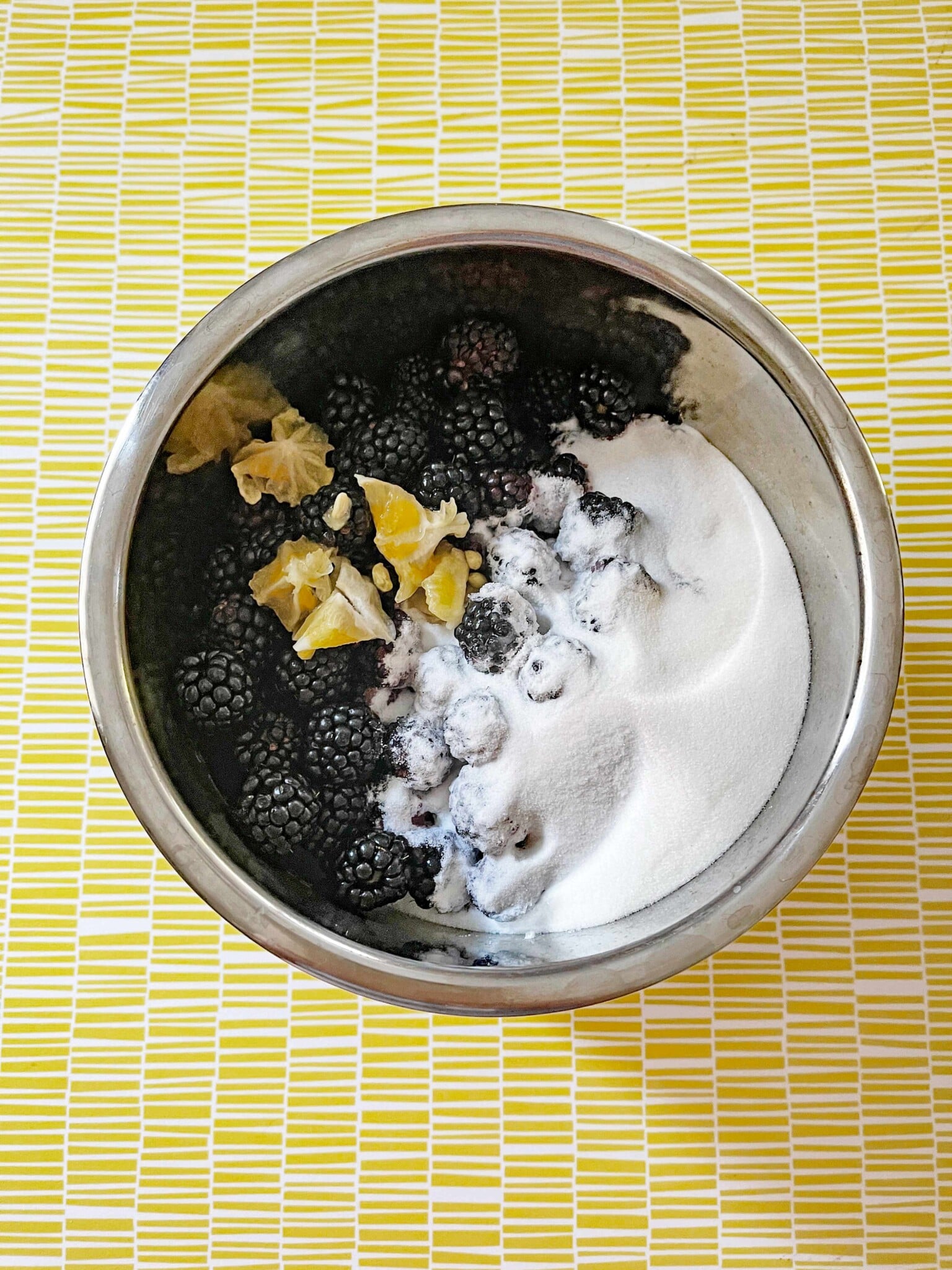 Instant Pot bowl with blackberries lemons and sugar.
