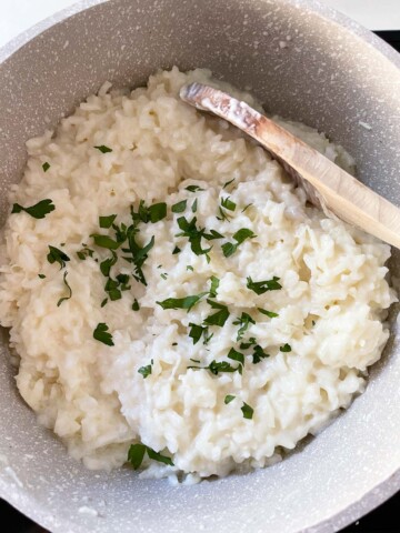 Parsley added to pot of rice.