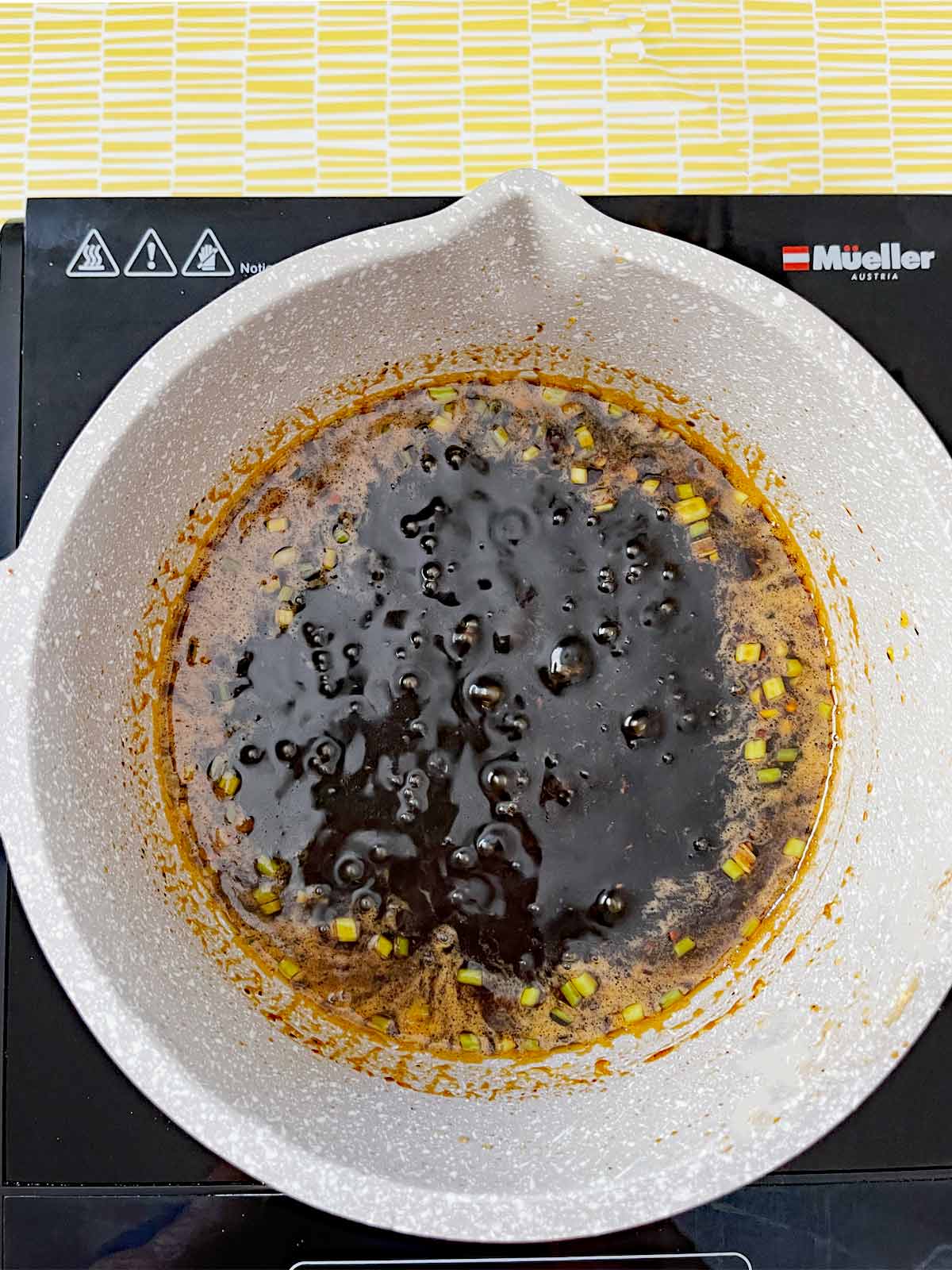 Sauce cooking on stove-top at a low simmer.