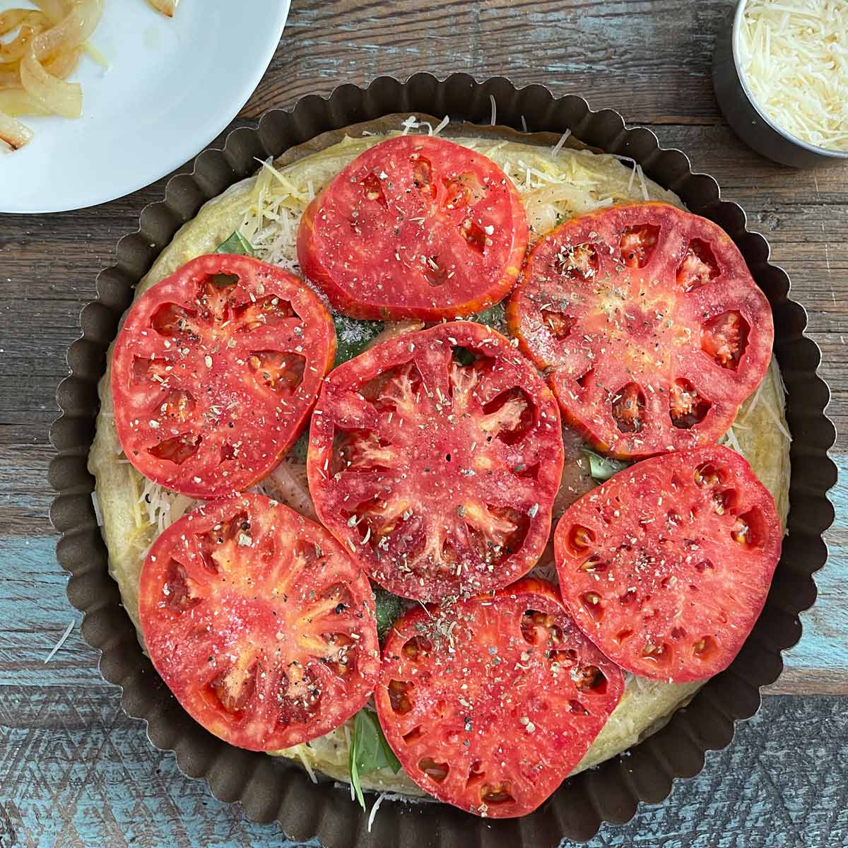 Tomato slices with salt, pepper, and dried herbs de Provence sprinkled on top.