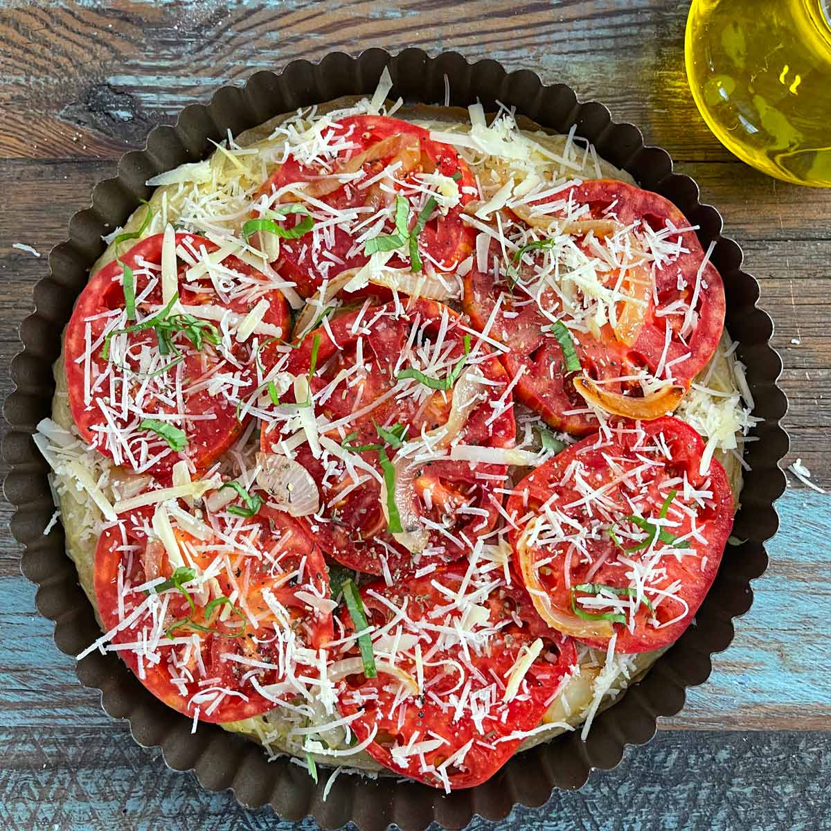 Tart with extra cheese and basil on top.
