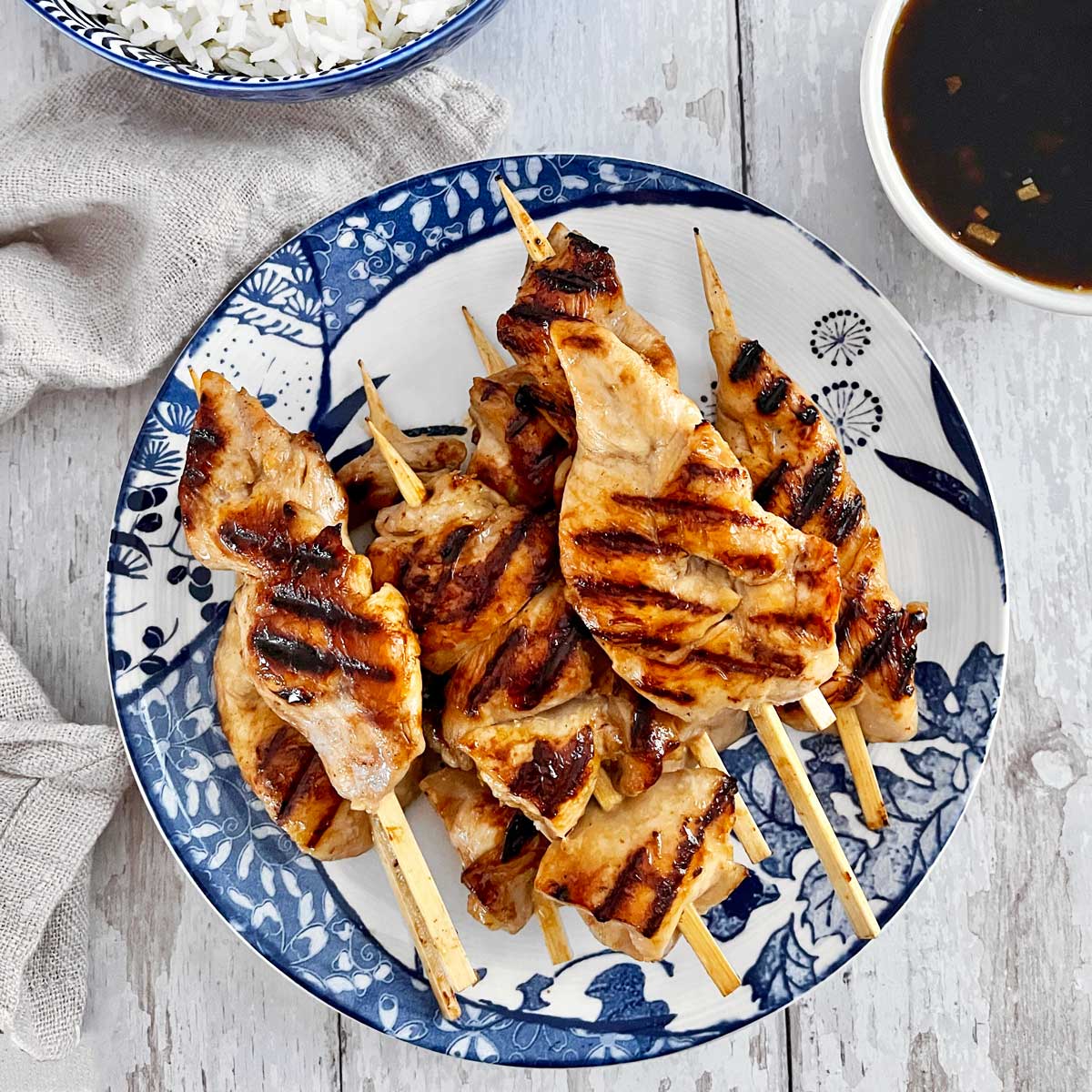 Fully cooked chicken on blue and white serving plate.
