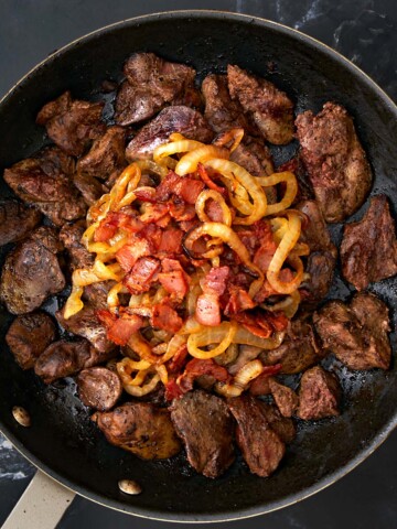 Liver and onions on a skillet.