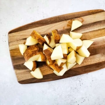 Chopped potatoes on a cutting board.