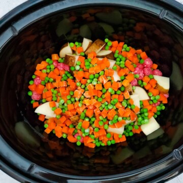 Peas and carrots added to crockpot.
